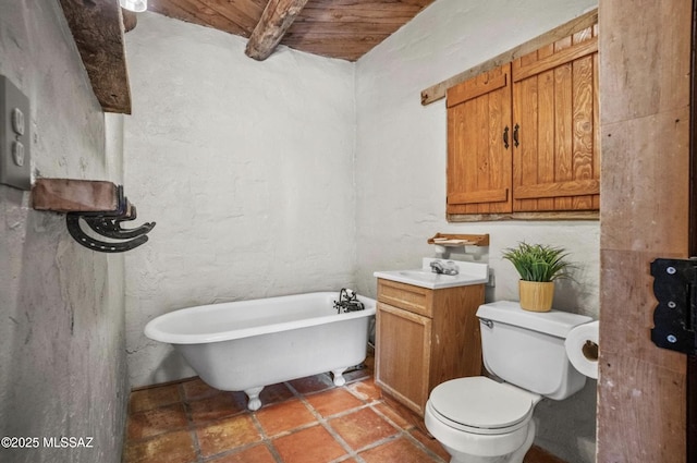 bathroom with toilet, wood ceiling, beamed ceiling, a freestanding bath, and vanity