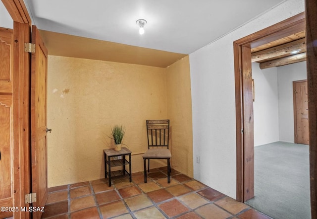 living area featuring beam ceiling