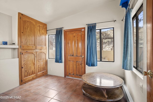 foyer with baseboard heating and light tile patterned flooring