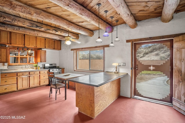 kitchen featuring wood ceiling, stainless steel gas stove, a sink, and a peninsula