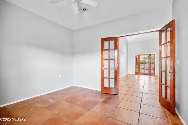 spare room with ceiling fan, visible vents, baseboards, and french doors