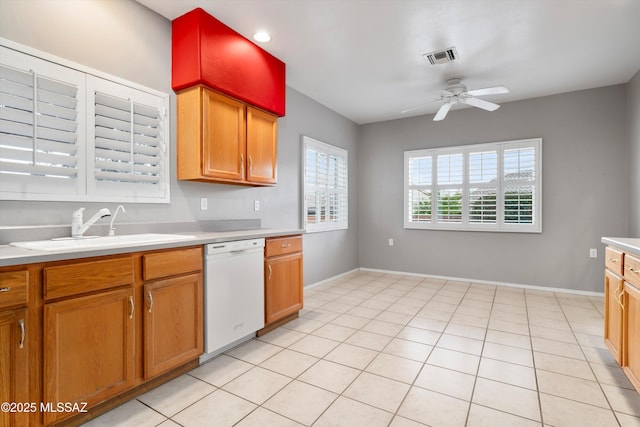 kitchen featuring light countertops, visible vents, a ceiling fan, a sink, and dishwasher