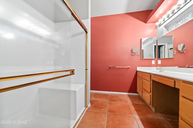 bathroom with a stall shower, vanity, and tile patterned floors