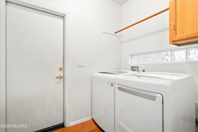 laundry area featuring cabinet space, independent washer and dryer, and light tile patterned floors