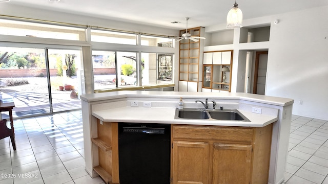 kitchen featuring black dishwasher, light countertops, light tile patterned floors, and a sink