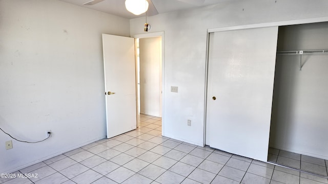 unfurnished bedroom with a closet and light tile patterned flooring