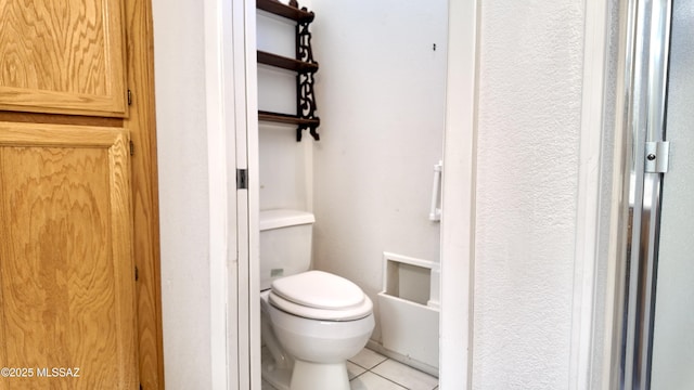 bathroom featuring toilet and tile patterned floors