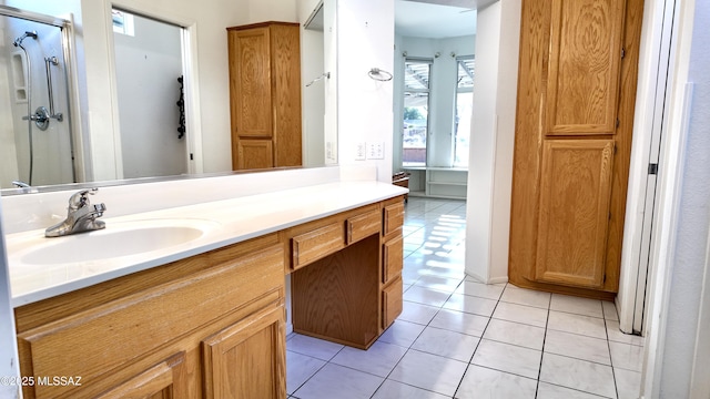 bathroom with a stall shower, vanity, and tile patterned floors