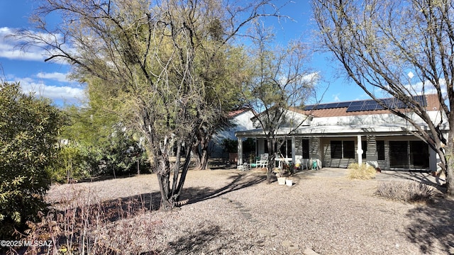 rear view of house with roof mounted solar panels