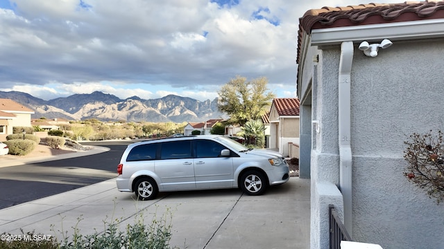 view of vehicle parking with a mountain view