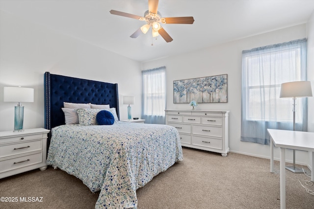 carpeted bedroom featuring baseboards and ceiling fan