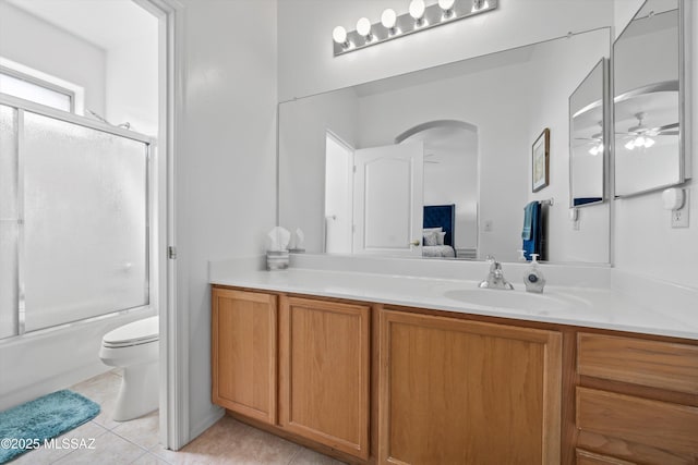 bathroom with vanity, a ceiling fan, tile patterned flooring, toilet, and connected bathroom