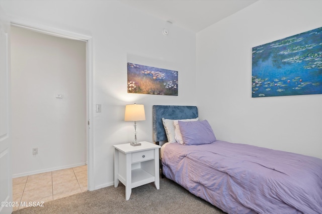 bedroom with tile patterned flooring, baseboards, and carpet floors