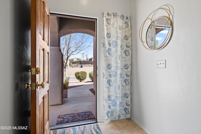 foyer featuring light tile patterned floors and plenty of natural light