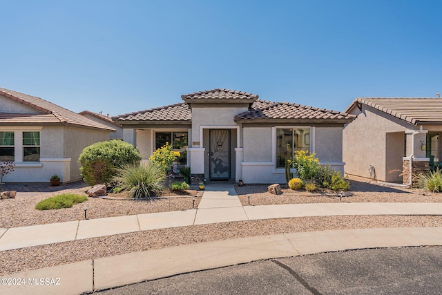 view of front of property with a tile roof and stucco siding