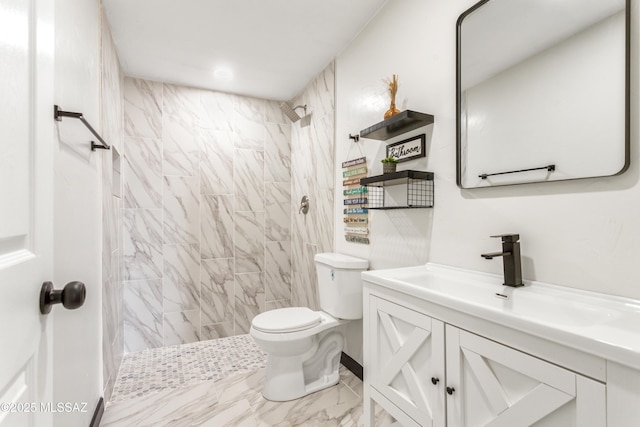 full bath with marble finish floor, vanity, a tile shower, and toilet