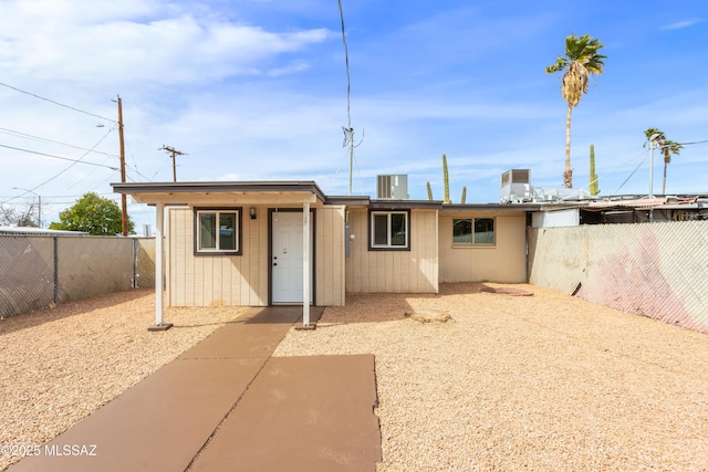 rear view of property with a fenced backyard