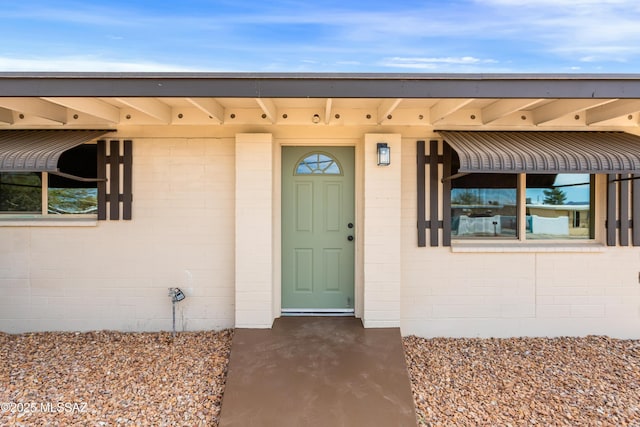 doorway to property with concrete block siding