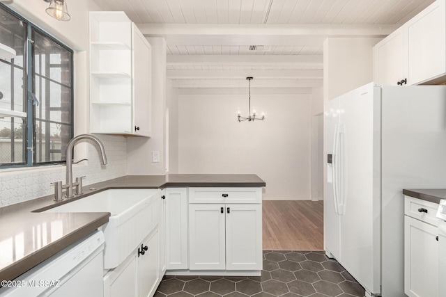 kitchen with white appliances, white cabinetry, and decorative backsplash