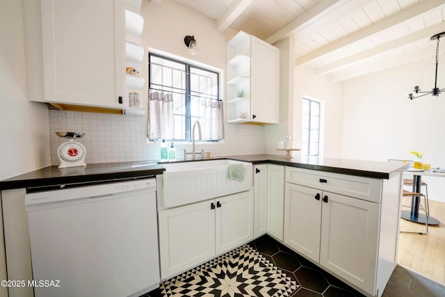 kitchen featuring open shelves, a peninsula, a sink, decorative backsplash, and dishwasher