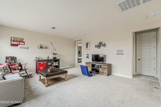 living room featuring visible vents, light carpet, and baseboards