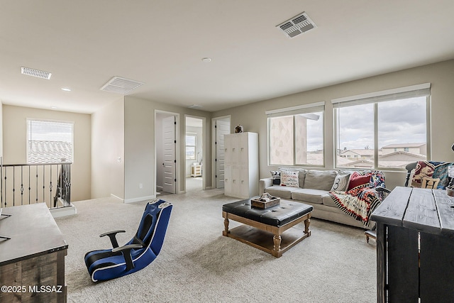 carpeted living room featuring visible vents and baseboards