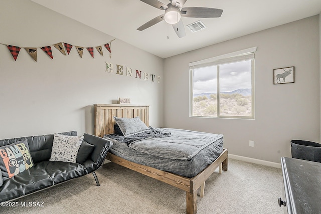 bedroom featuring light carpet, baseboards, visible vents, and a ceiling fan