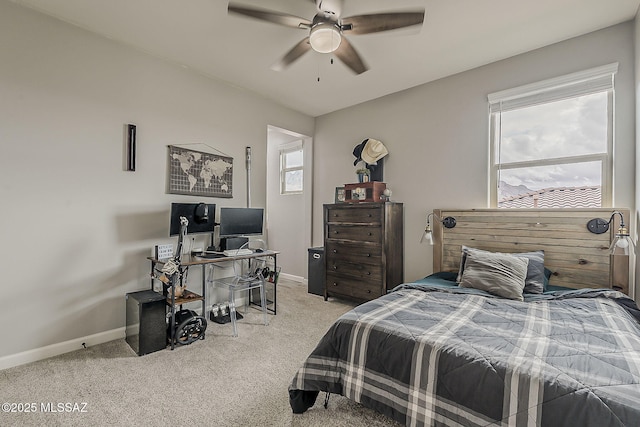 bedroom with a ceiling fan, carpet flooring, and baseboards