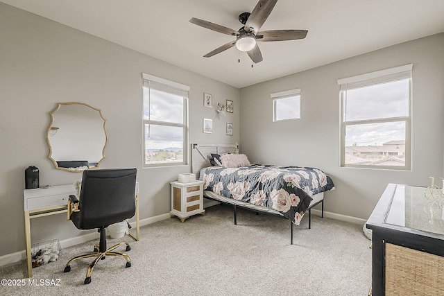 bedroom with baseboards, ceiling fan, and light colored carpet