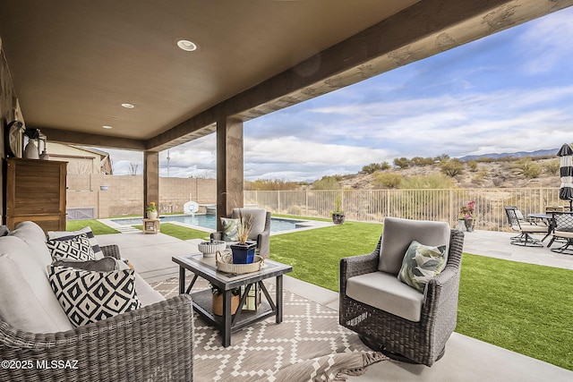 view of patio featuring a fenced backyard, outdoor lounge area, and a fenced in pool