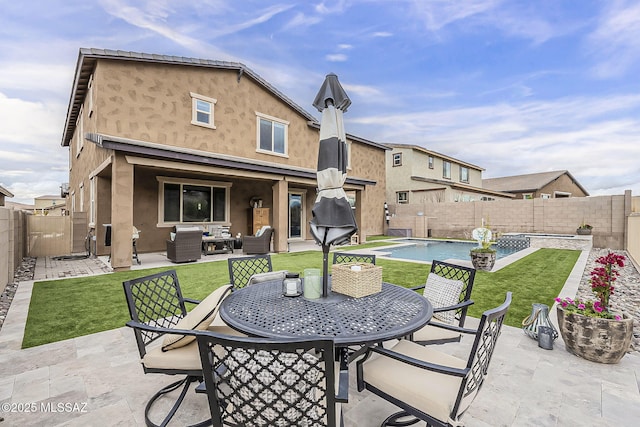 view of patio featuring a fenced backyard, outdoor dining area, and a fenced in pool