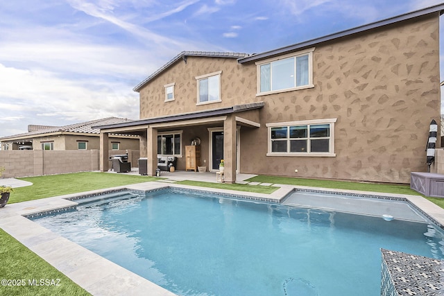 back of house featuring a patio, fence private yard, and stucco siding