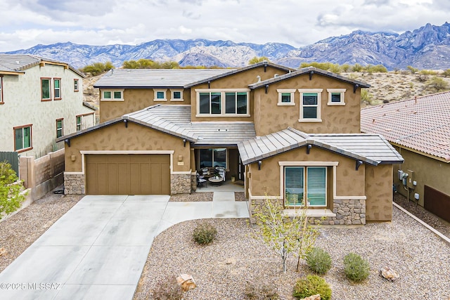 view of front of property with stone siding, a mountain view, a tiled roof, and fence