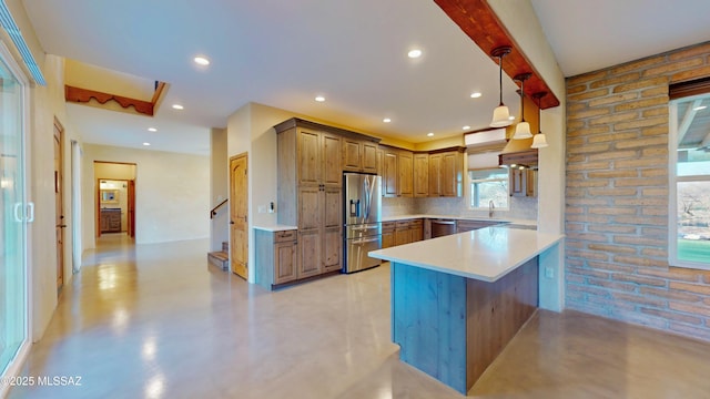 kitchen with appliances with stainless steel finishes, concrete flooring, a peninsula, and decorative backsplash