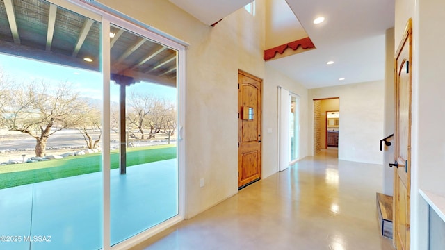 doorway to outside with recessed lighting and finished concrete flooring