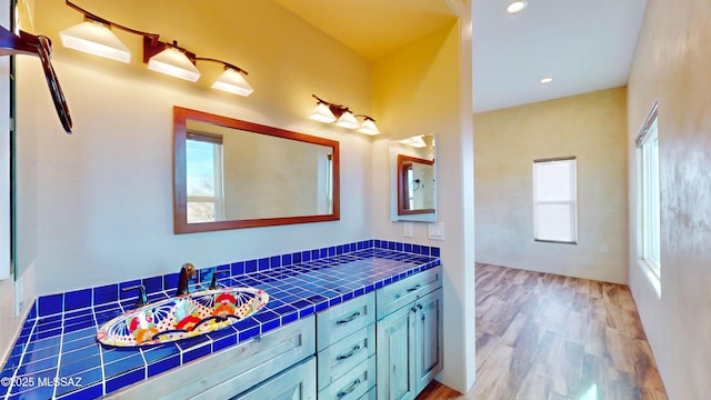 bathroom with recessed lighting, vanity, and wood finished floors