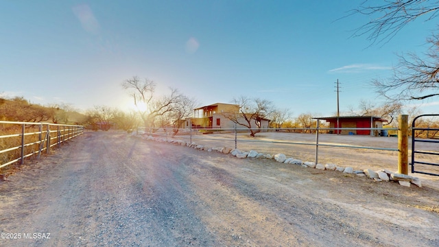 view of street featuring a rural view and dirt driveway