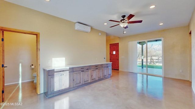 empty room featuring a wall unit AC, ceiling fan, finished concrete flooring, and recessed lighting