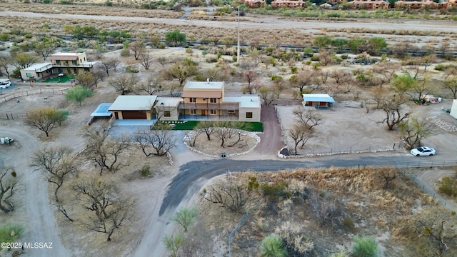 drone / aerial view featuring view of desert and a rural view