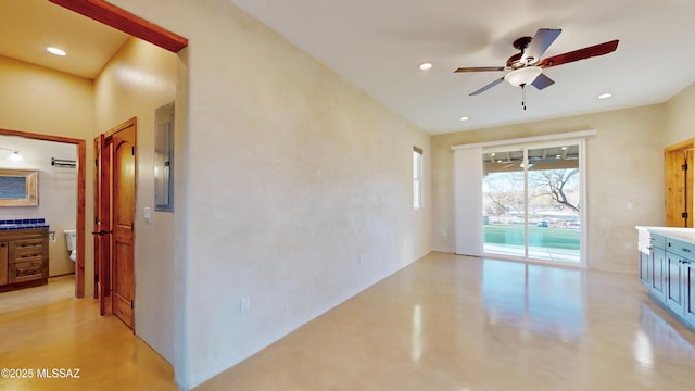 interior space featuring ceiling fan, concrete floors, and recessed lighting