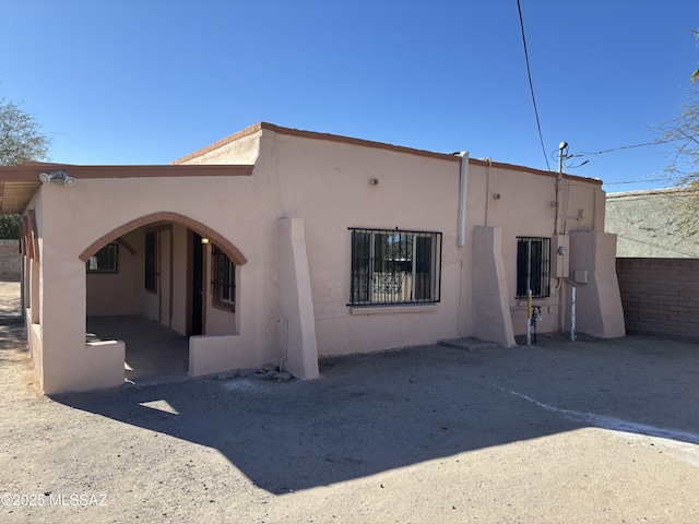 back of house featuring stucco siding