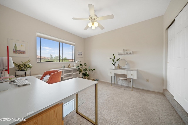 office with ceiling fan, baseboards, and light colored carpet