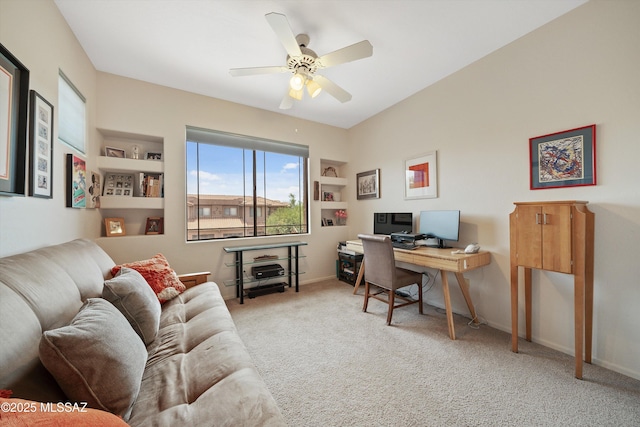 carpeted office space with a ceiling fan and baseboards