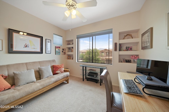 office space with carpet floors, baseboards, and a ceiling fan