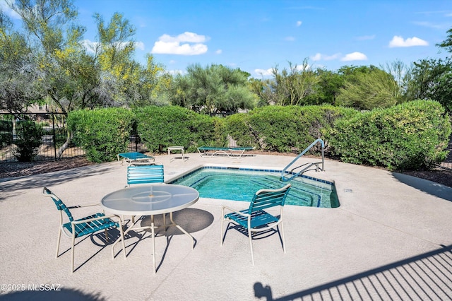 view of swimming pool featuring a pool, a patio, and fence