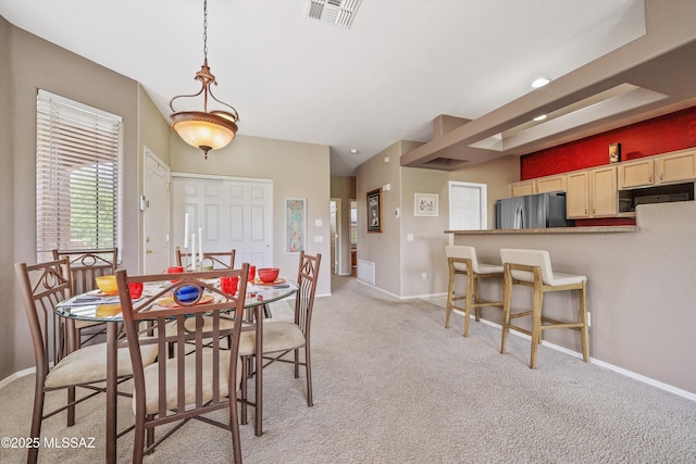 dining space with visible vents, light carpet, and baseboards