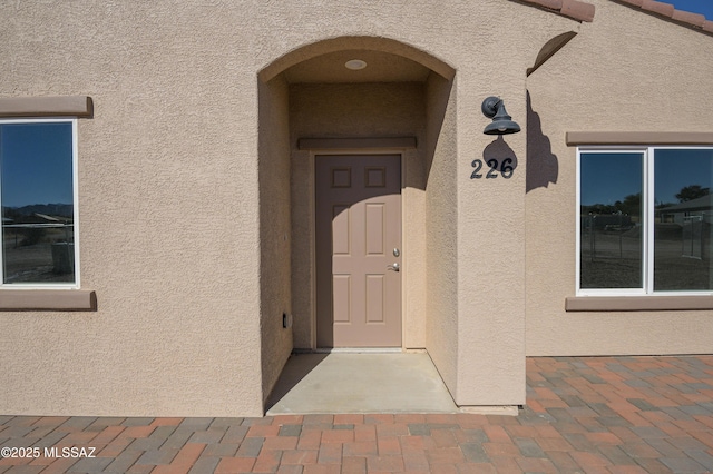 property entrance featuring stucco siding