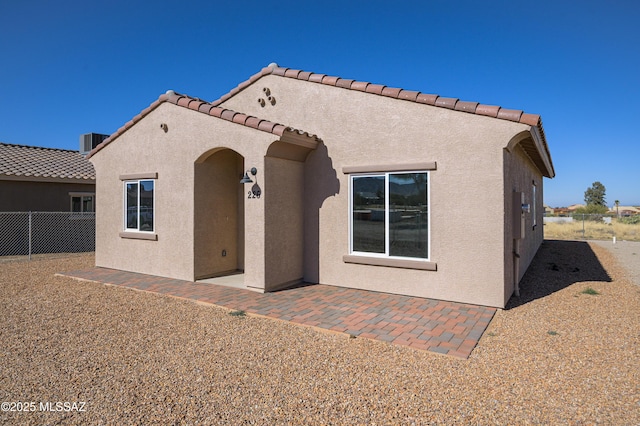 back of house with a patio area, fence, and stucco siding