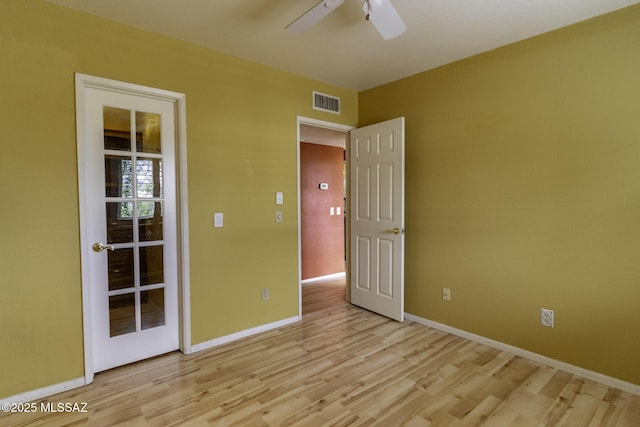 spare room featuring visible vents, baseboards, light wood-style floors, and ceiling fan