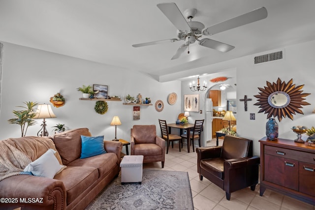 living room with arched walkways, visible vents, a ceiling fan, and light tile patterned floors